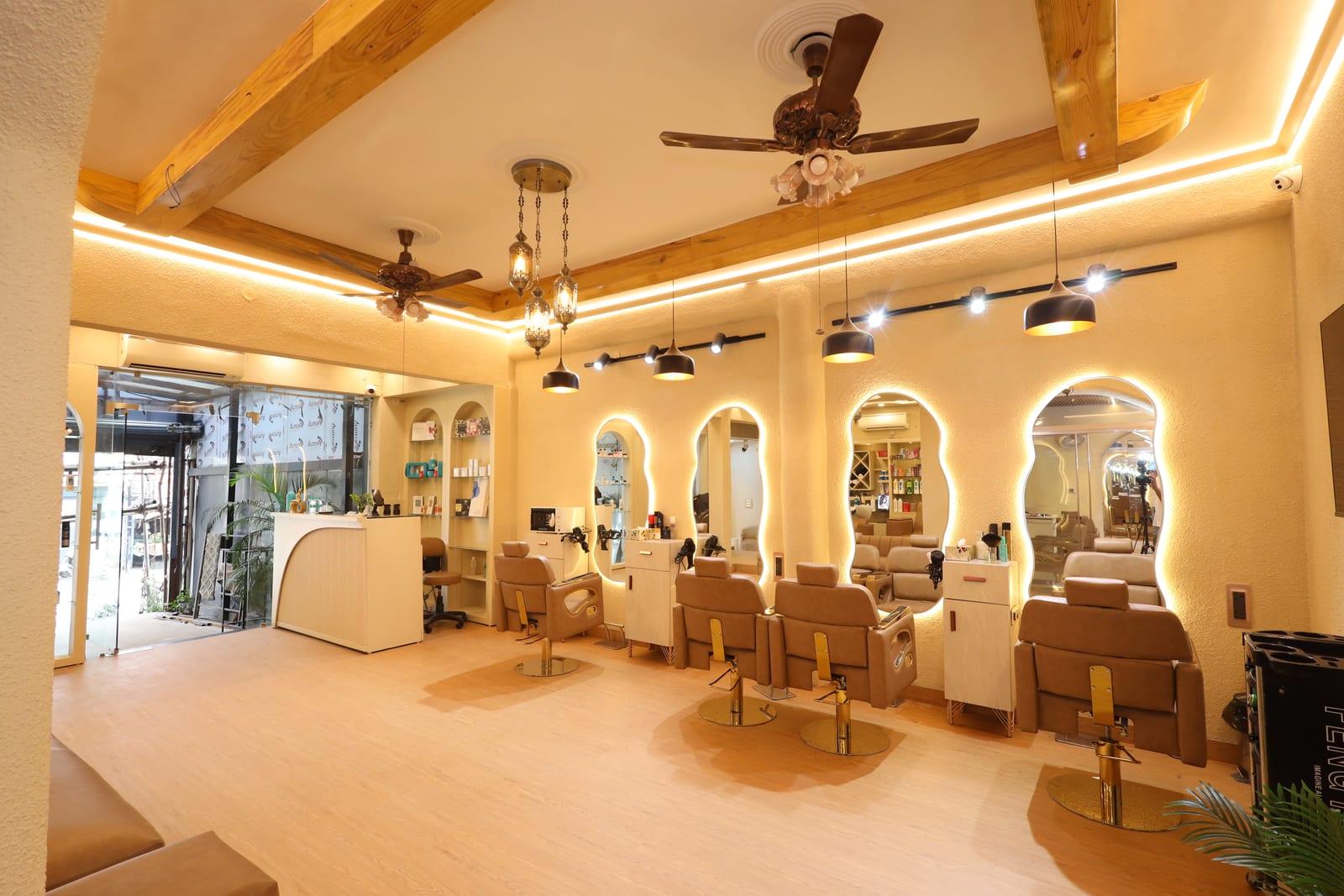 Backlit arched mirrors and styling stations at Rare Salon