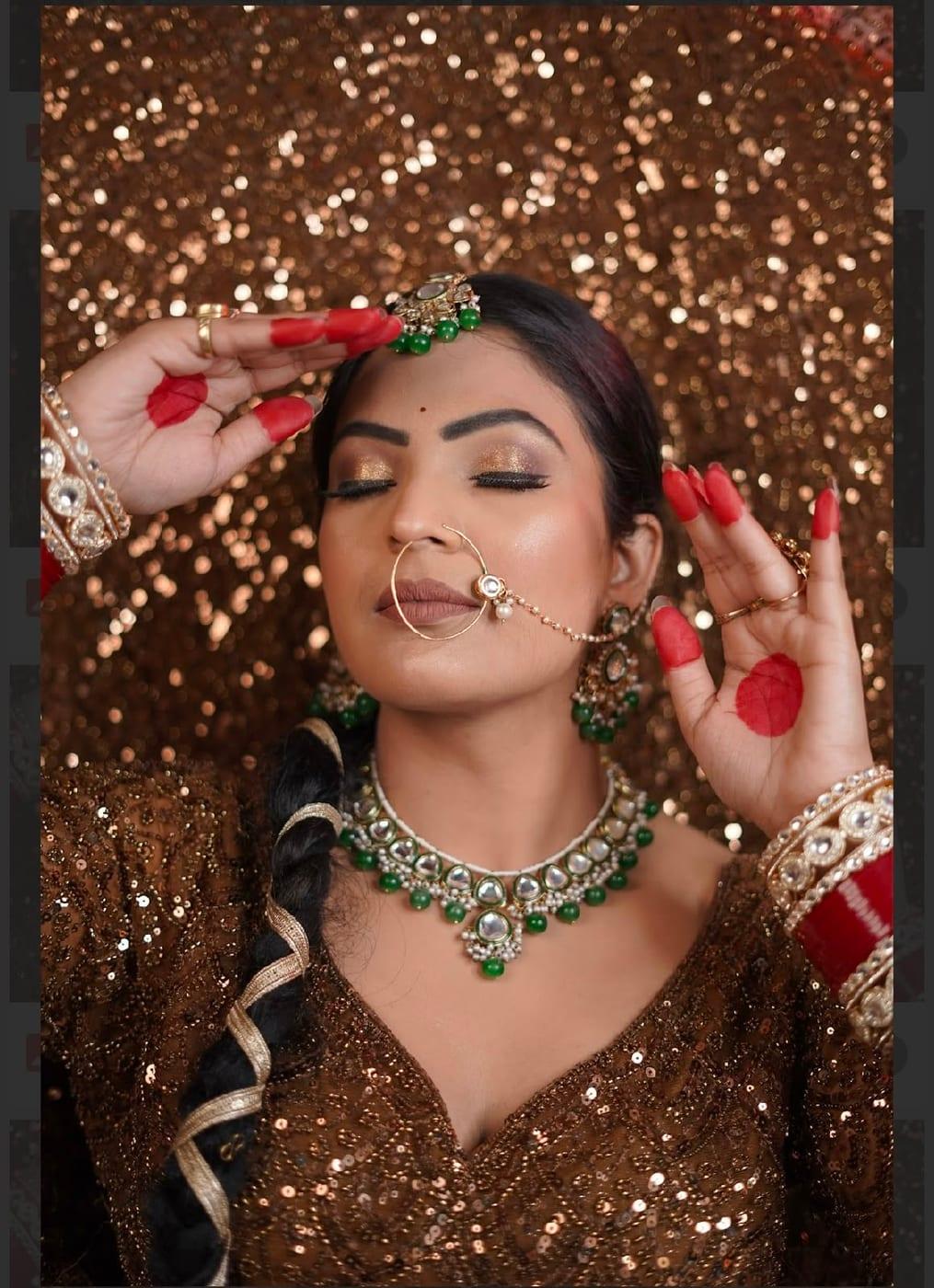 Royal maroon bride with emerald jewellery and golden eyes