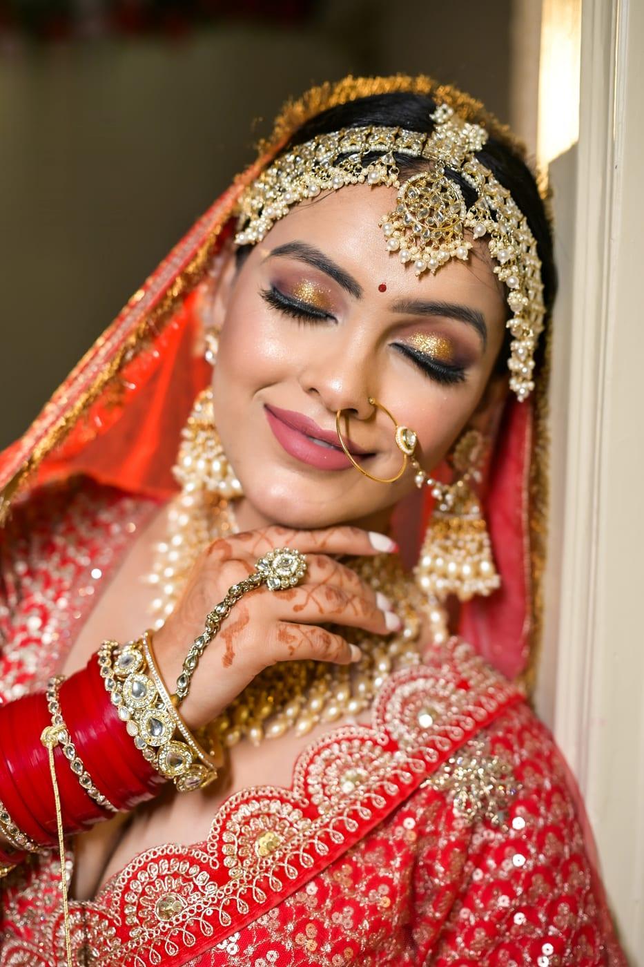 Classic red bride with statement nath, close portrait