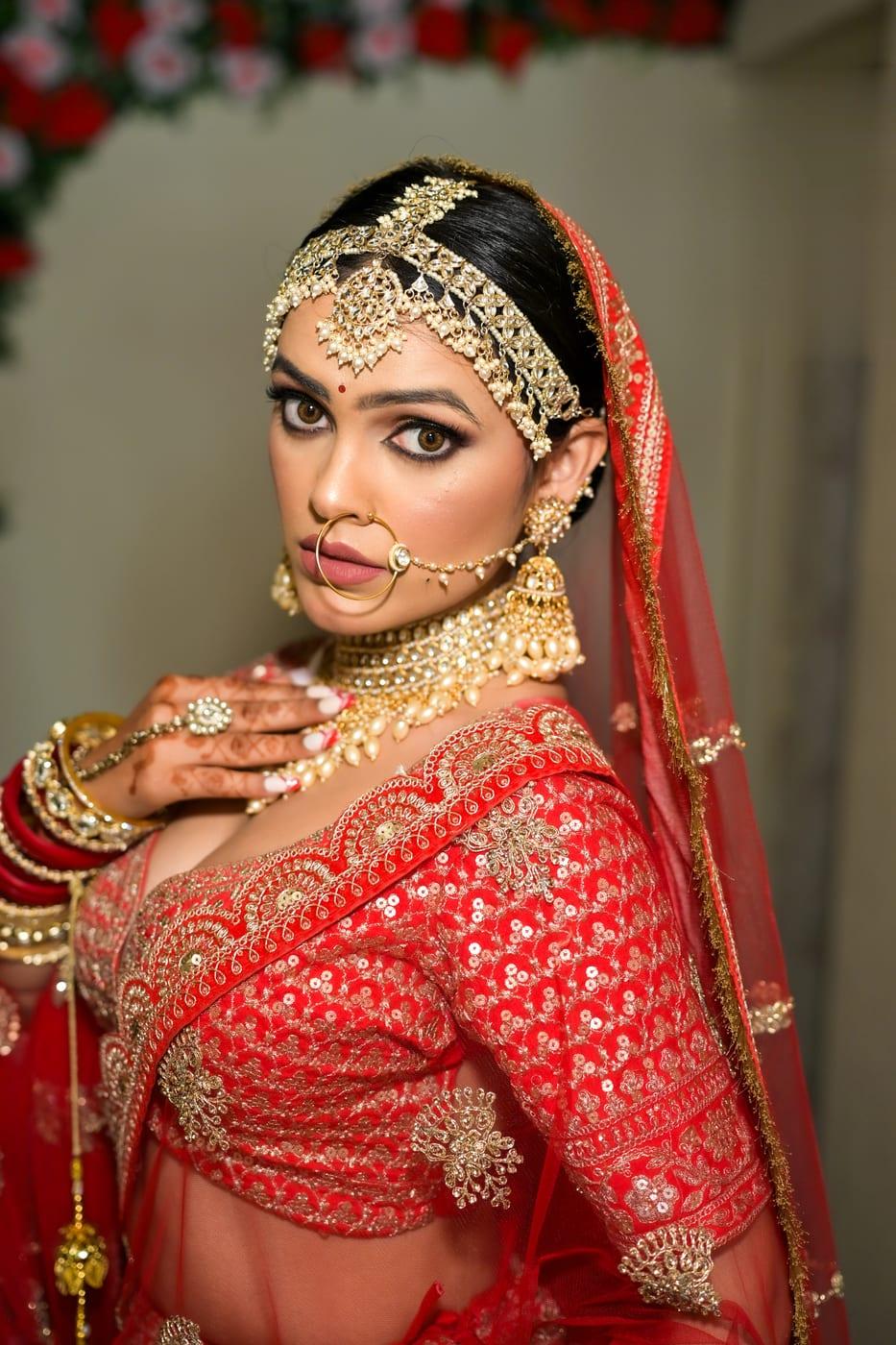 Classic red bridal makeup with statement nath by Rare Salon, Dehradun