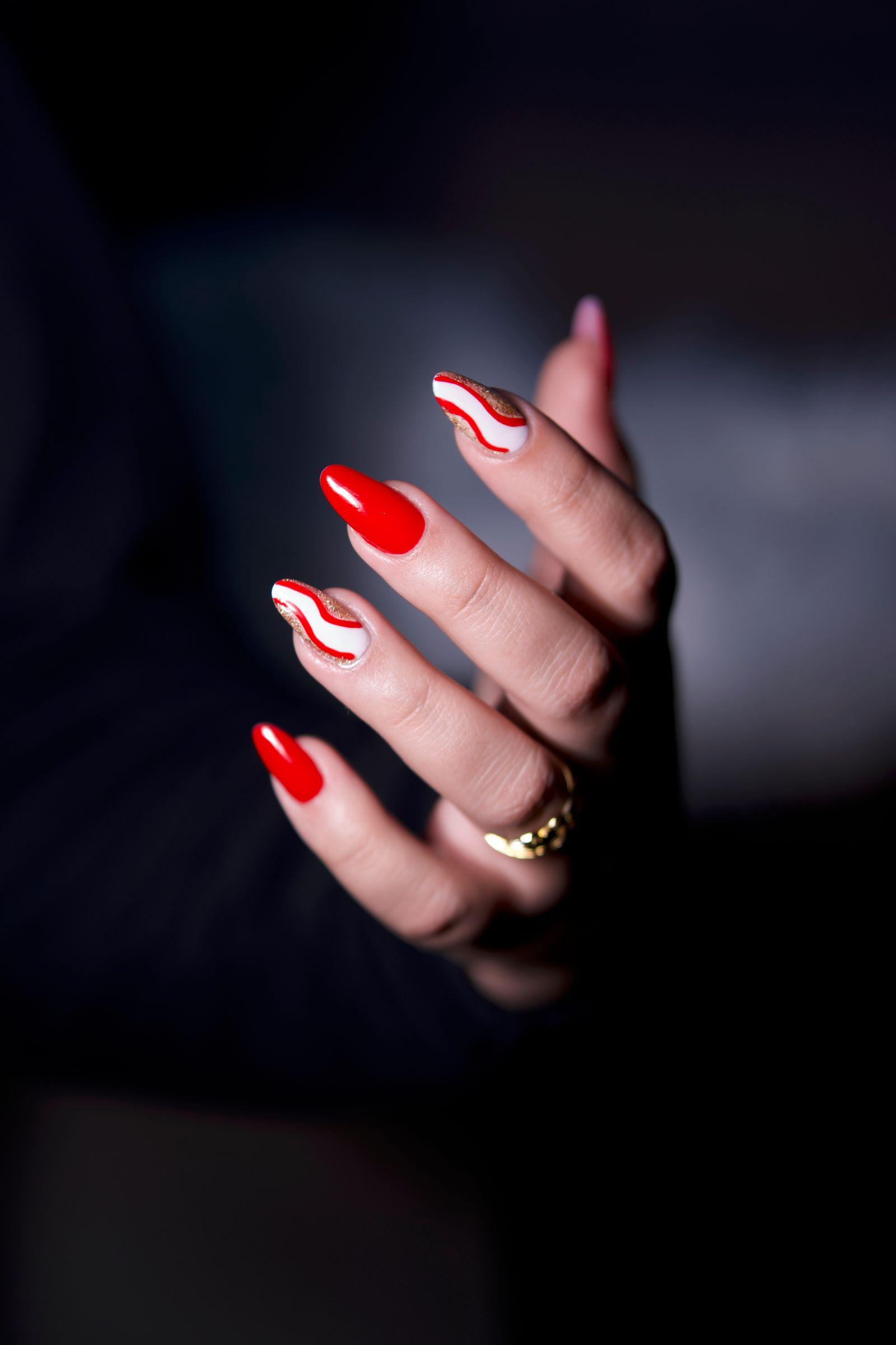 Glossy red gel manicure, close-up