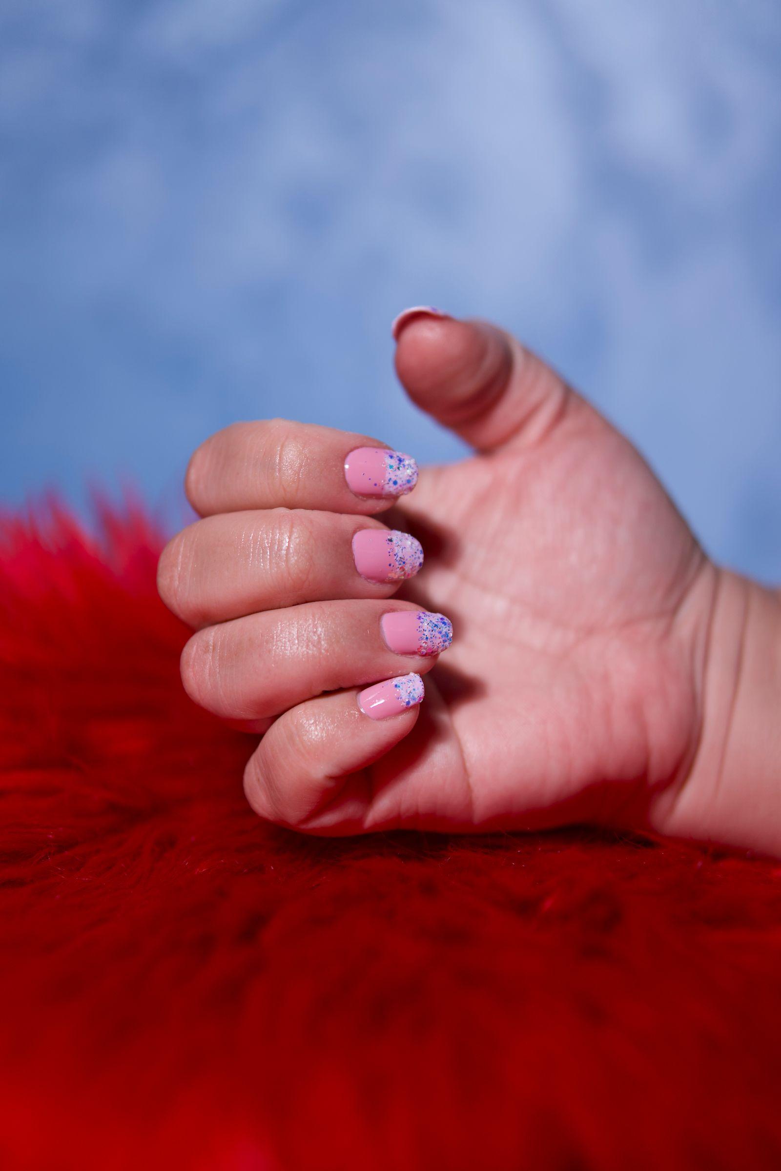 Baby-pink nails with blue glitter ombré tips