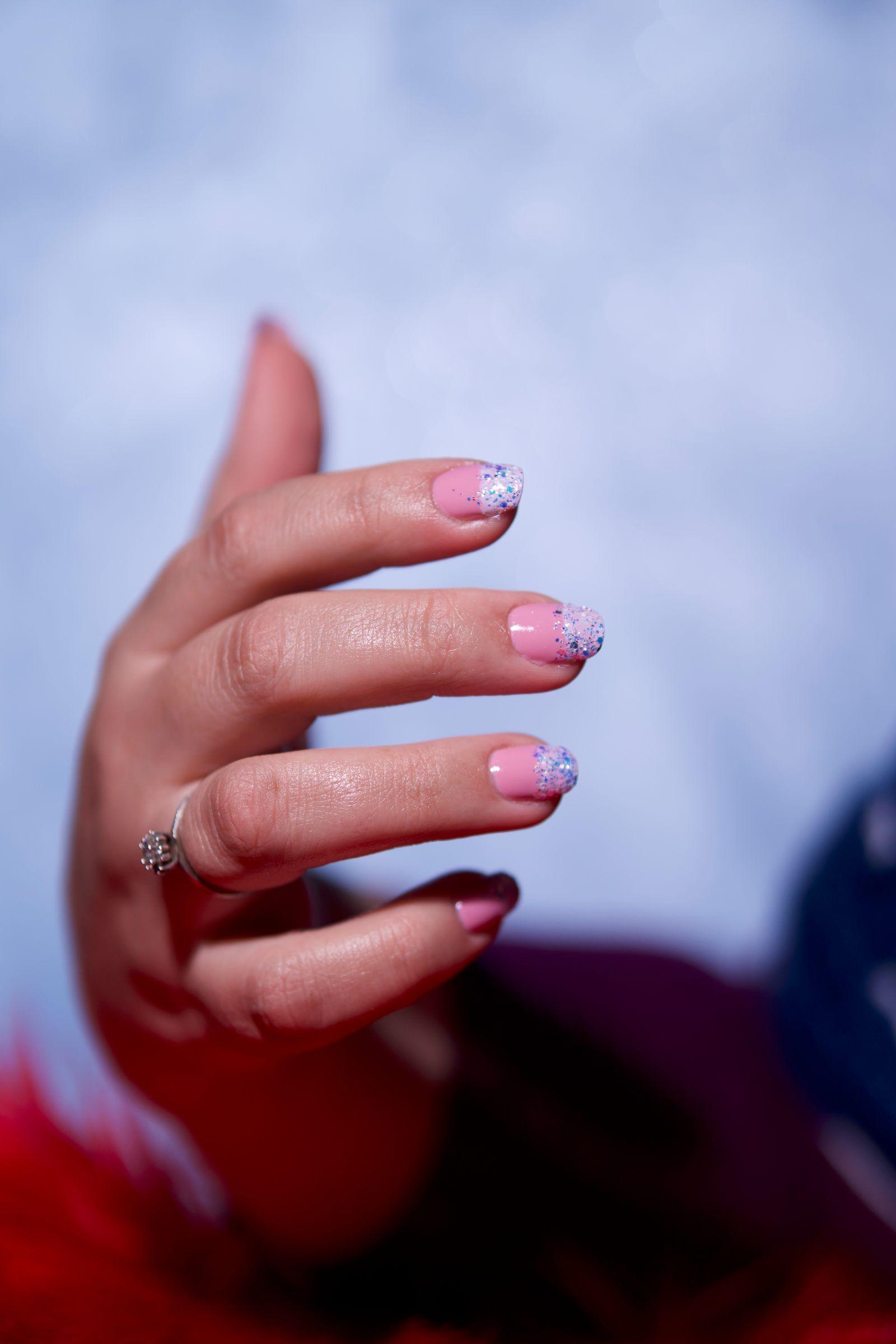 Soft pink nails with delicate glitter detailing